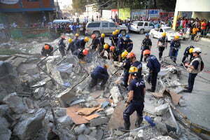 Members of the Los Angeles County Fire Department Search and Rescue Team clear debris at a collapsed building in downtown Port-au-Prince, Haiti, Jan. 17, 2010. (U.S. Navy photo by Mass Communication Specialist 2nd Class Justin Stumberg/Not Released)